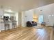Open-concept living room with sleek wood floors, vaulted ceilings, and stainless steel kitchen appliances at 3465 Jones Ferry Ln, Alpharetta, GA 30022