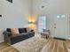Well-lit living room with a comfortable sofa, plush rug, and a view of the front yard at 3465 Jones Ferry Ln, Alpharetta, GA 30022