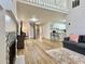 Spacious living room featuring hardwood floors, a cozy sofa, and staircase leading to upper level at 3465 Jones Ferry Ln, Alpharetta, GA 30022