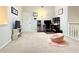 Loft area features neutral walls and carpet, plus a cozy seating area and computer desk for work or studying at 3465 Jones Ferry Ln, Alpharetta, GA 30022
