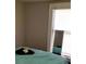 Comfortable bedroom with a window view and mirror at 571 Grant Sw St, Atlanta, GA 30315