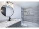 Bathroom with a vessel sink, gray vanity, modern vanity light, and shower-tub with gray tile at 8 Cantey Nw Pl, Atlanta, GA 30327