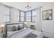 Cozy bedroom with a large window, neutral color palette, and modern light fixture at 8 Cantey Nw Pl, Atlanta, GA 30327