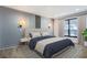 Serene bedroom featuring neutral decor, modern lighting, and large windows at 8 Cantey Nw Pl, Atlanta, GA 30327