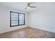 Bright bedroom featuring wood flooring, a ceiling fan and a large window for natural light at 8 Cantey Nw Pl, Atlanta, GA 30327