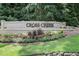Stone sign for Cross Creek community with colorful flowers and landscaping at 8 Cantey Nw Pl, Atlanta, GA 30327
