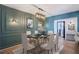 Elegant dining room featuring decorative wall paneling, modern lighting, and seating for six at 8 Cantey Nw Pl, Atlanta, GA 30327