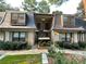 Charming townhome featuring a brick facade, dormer windows, and inviting landscaping at 8 Cantey Nw Pl, Atlanta, GA 30327