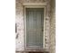 Stylish gray front door featuring classic paneling and brass hardware on a brick building at 8 Cantey Nw Pl, Atlanta, GA 30327