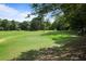 Expansive golf course showcasing meticulously maintained green with golfers enjoying a sunny day at 8 Cantey Nw Pl, Atlanta, GA 30327