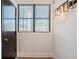 Entryway with a modern light fixture, black door, white walls, and a large window with natural light at 8 Cantey Nw Pl, Atlanta, GA 30327