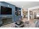 Inviting living room features custom built-ins, fireplace, and view into the dining area at 8 Cantey Nw Pl, Atlanta, GA 30327