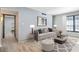 Bright living room with contemporary furnishings, wood floors, and large windows at 8 Cantey Nw Pl, Atlanta, GA 30327