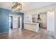 Open-concept space with light wood floors and a kitchen island with bar seating at 8 Cantey Nw Pl, Atlanta, GA 30327