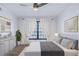 Bright main bedroom with a ceiling fan, gray bedding, and a window with white curtains at 8 Cantey Nw Pl, Atlanta, GA 30327