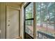 Patio with screen door looking out at steps, trees and a parked car on the street at 8 Cantey Nw Pl, Atlanta, GA 30327