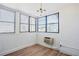Bright sun room featuring wood flooring, natural light and brick accent wall at 8 Cantey Nw Pl, Atlanta, GA 30327