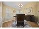Elegant dining room with a stylish chandelier, large windows, and wainscoting at 129 Windy Cir, Mcdonough, GA 30253