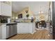 Well-equipped kitchen with stainless steel appliances, granite counters, and an open view to the dining area at 129 Windy Cir, Mcdonough, GA 30253