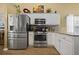 Bright kitchen with stainless steel appliances, granite countertops, and ample cabinet space at 129 Windy Cir, Mcdonough, GA 30253