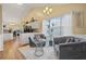 Cozy living room featuring luxury furniture, wood floors, and a view into the kitchen at 129 Windy Cir, Mcdonough, GA 30253