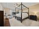 Main bedroom with tray ceilings, ceiling fan, a four-poster bed, and a sitting area at 129 Windy Cir, Mcdonough, GA 30253