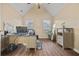 Bright home office boasts wood floors, a ceiling fan, and multiple windows for natural light at 129 Windy Cir, Mcdonough, GA 30253