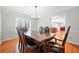 Elegant dining room with hardwood floors, crown molding, and modern chandelier at 2740 Woodbine Hill Way, Norcross, GA 30071