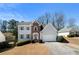 Traditional two-story home with brick accents, attached garage, and mature landscaping at 2740 Woodbine Hill Way, Norcross, GA 30071