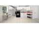 Bright kitchen features white cabinets, a black oven, and a view to the outside at 2740 Woodbine Hill Way, Norcross, GA 30071