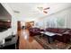 Open-concept living room features hardwood floors, ceiling fan, and large windows at 2740 Woodbine Hill Way, Norcross, GA 30071