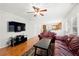 Living room boasts hardwood floors, large TV, and easy access to kitchen and dining area at 2740 Woodbine Hill Way, Norcross, GA 30071