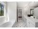 A full main bathroom with double sink vanity, soaking tub, and tiled flooring at 2740 Woodbine Hill Way, Norcross, GA 30071