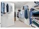 Walk-in closet featuring ample hanging space and shelving for organization at 2740 Woodbine Hill Way, Norcross, GA 30071