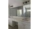 A modern bathroom offers double sinks and a view of a tiled shower at 3076 Zodiac Ct, Lawrenceville, GA 30044