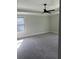 Carpeted bedroom features a ceiling fan and a window with natural light at 3076 Zodiac Ct, Lawrenceville, GA 30044