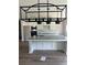 Bright kitchen with granite counters, a center island, stainless steel appliances and a stylish modern lighting fixture at 3076 Zodiac Ct, Lawrenceville, GA 30044