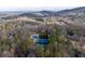 An aerial view of community pool, tennis courts, and wooded surroundings, offering scenic recreation at 4411 Windsor Oaks Cir, Marietta, GA 30066