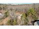 A bird's eye view of the home nestled among trees showcasing its privacy and wooded surroundings at 4411 Windsor Oaks Cir, Marietta, GA 30066