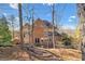 Back of house with multiple windows and doors, trees, and landscaping showing the natural beauty of the property at 4411 Windsor Oaks Cir, Marietta, GA 30066