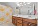 Bright bathroom featuring double sink vanity and a sunflower-themed shower curtain, adding a cheerful touch at 4411 Windsor Oaks Cir, Marietta, GA 30066