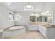 Bright bathroom featuring a soaking tub, granite countertops, dual vanities, and tile floors at 4411 Windsor Oaks Cir, Marietta, GA 30066