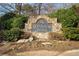 Elegant stone community entrance sign amidst lush landscaping at 4411 Windsor Oaks Cir, Marietta, GA 30066