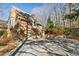 Charming brick home featuring a two-car garage and a spacious driveway surrounded by mature trees at 4411 Windsor Oaks Cir, Marietta, GA 30066
