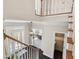 Bright foyer with hardwood floors, white staircase, and views into other rooms at 4411 Windsor Oaks Cir, Marietta, GA 30066