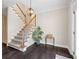 Sunlit foyer featuring dark hardwood floors, a staircase, and stylish lighting fixture at 4411 Windsor Oaks Cir, Marietta, GA 30066