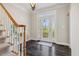 Inviting foyer with hardwood floors, staircase, and an elegant front door with glass details at 4411 Windsor Oaks Cir, Marietta, GA 30066