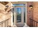 Elegant glass front door with sidelights, flanked by classic lanterns and brick facade at 4411 Windsor Oaks Cir, Marietta, GA 30066