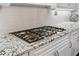 Close up of a granite countertop and stovetop at 4411 Windsor Oaks Cir, Marietta, GA 30066