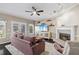 Cozy living room features a fireplace, ceiling fan, and plush furniture at 4411 Windsor Oaks Cir, Marietta, GA 30066